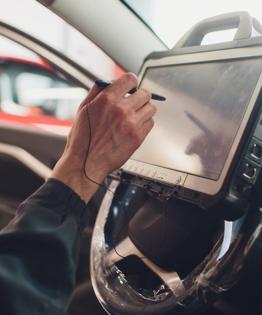 Mechanucs using a computer to diagnose a vehicle - Vehicle Diagnostics Holderness