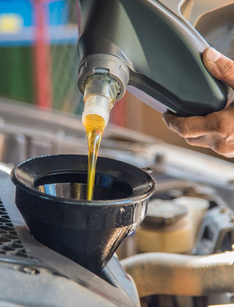 Mechanic pouring engine oil into a vehicle - Car Servicing Holderness